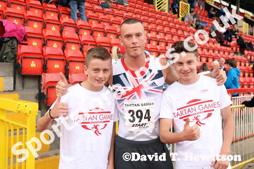 Richard Kilty (Gateshead) with two youngsters at the Gateshead Tartan Games Open.